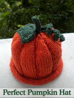 a knitted pumpkin hat sitting on top of a white surface