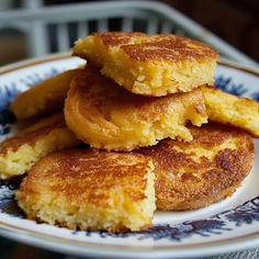 some fried food is stacked on top of each other in a blue and white plate