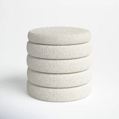 four white sponges stacked on top of each other in front of a white background