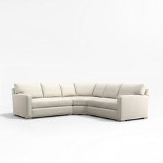 a white sectional couch sitting on top of a white floor