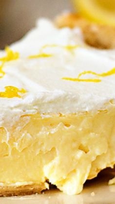 a close up of a piece of cake with frosting and lemons on it