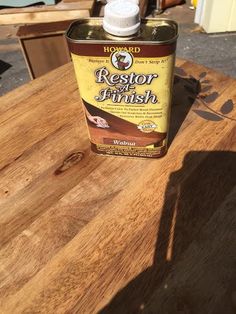 a bottle of restore finish sitting on top of a wooden table