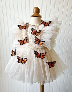 This Boho Butterfly Dress is made with a beige lace fabric. It is adorned with tulle and embellished with Monarch Butterflies. The back of the romper has an open back, giving it the perfect look. It will be enclosed with a tulle ribbon.  All of my items are made in a smoke free home and will be mailed in a box to ensure safety of the romper.   Size Chart                                                Measured in Inches                             Newborn/Preemie:     Chest - 15.5 Waist - 16 Hips Dress-up Tulle Dresses With Lace Patchwork, Tulle Dress With Lace Patchwork For Dress-up, Fitted Tulle Lace Dress For Pageants, Fitted Tulle Lace Dress For Pageant, Cream Tulle Dress For Garden Party, Cream Ruffled Tutu Dress For Party, Fitted Tutu Dress With Lace Patchwork For Dress-up, Fitted Lace Patchwork Tutu Dress For Dress-up, Garden Party Tulle Dress With Lace Patchwork