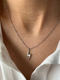 Lightning of the night ⚡ Get this beautiful minimalist jewelry made with the quality of perfect elements✨ You can choose 925K Sterling Silver with the options of Gold, Rose Gold or White Gold colors High quality jewelry for everyone 🤍 Details * 925K Sterling Silver Option → 14K Gold, Rose Gold or White Gold plated * Chain length is approximately 18 inches (16+2 in extender) / 45 cm (40+5 cm extender) * Time is everything! You will receive your package as soon as possible 🚚 * We care about the quality of metal to make sure it will last for a long time * We use enamel technique to color the jewelry and high quality zircons only * There can be tiny differences on each item. Length difference of the chain as well as color changes and shade differences of the stones and enamel is possible sin Everyday Silver 14k Gold Charm Necklace, Minimalist Sterling Silver Charm Necklaces, Tarnish Resistant, Minimalist Sterling Silver Charm Necklaces, Minimalist Sterling Silver Charm Necklace Tarnish Resistant, Minimalist Sterling Silver Charm Necklace, Tarnish Resistant, Minimalist White Gold Pendant Charm Necklace, Simple White Gold Jewelry With Polished Finish, Simple Polished White Gold Jewelry, Minimalist Sterling Silver Tarnish Resistant Jewelry