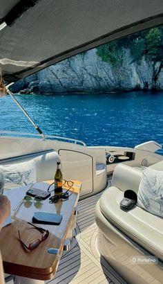 a woman sitting at a table on top of a boat