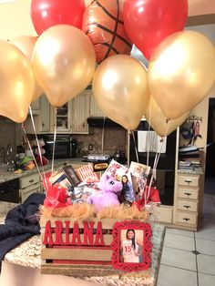 a bunch of balloons that are on top of a box with some pictures in it