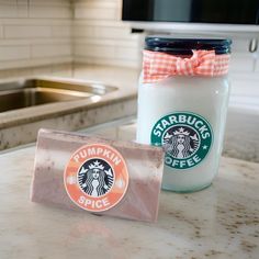 there is a starbucks coffee cup and a cookie in a jar on the counter top