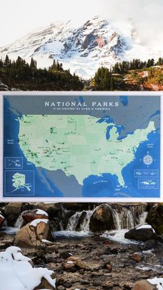 a large sign with a map on it in front of a waterfall and snow covered mountain