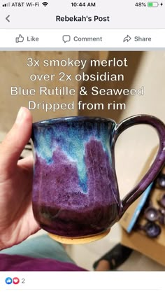 someone is holding up a mug with blue and purple swirls on it