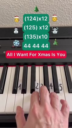 someone is playing the piano with christmas decorations on it's back and numbers above them