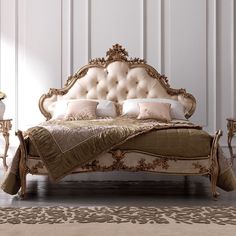 a fancy bed with gold and white furniture in a room that looks like it could be used as a bedroom