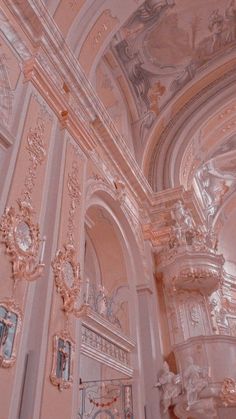 the interior of an ornate building with pink walls