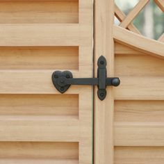 a close up of a wooden door with an iron handle on the front and side