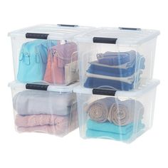 three plastic storage containers filled with different types of clothes and bags on top of each other