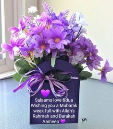 purple flowers in a vase with a card saying, salamas love eida wishing you a mubarak week full with allaah's rahma and barak