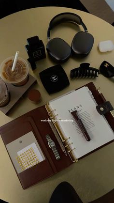 the contents of an office desk with headphones, notebooks and other personal items