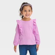 Spruce up your little one’s warm-weather closet with this Long-Sleeve T-Shirt from Cat & Jack™. Crafted from drop-needle, cotton-blend fabric with just the right amount of spandex, this long-sleeve tee offers all-day flexible comfort that moves with them. Ruffle detailing along the shoulders and waist adds depth to the overall look, while the purl-edge hem lends sweet style. Pair with a variety of their fave shorts or pants to create comfy, versatile outfits. Cat & Jack™: Designed for all childr Spring Crew Neck Tops For Playtime, Crew Neck Tops For Playtime In Spring, Crew Neck Tops For Spring Playtime, Pink Fall Playwear Top, Pink Tops For Playtime During Fall, Pink Tops For Playtime In Fall, Spring Cotton Heather Tops, Cute Purple Top For Spring, Spring Heather Cotton Tops