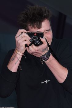 a man holding a camera up to his face