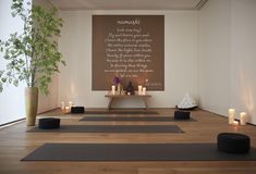 a yoga room with candles and an advertisement on the wall