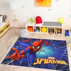 a bedroom with a spiderman rug in the middle and toys on the floor next to it