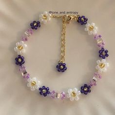 a bracelet with flowers and beads on it