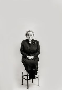 an older woman sitting on top of a chair