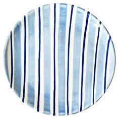 a blue and white striped plate on a white background, with horizontal stripes in the center