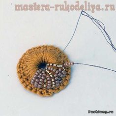 a crocheted object with beads and thread