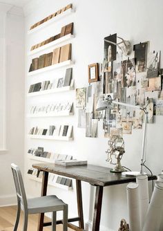 a table and chairs in a room with pictures on the wall