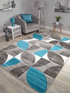 a living room area rug with blue and gray circles on the floor, in front of a chair