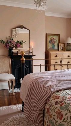 a bed room with a neatly made bed and a chandelier