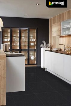 a modern kitchen with black and white tile flooring