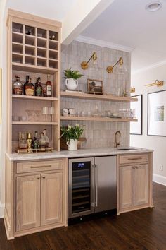 a kitchen with wooden cabinets and shelves filled with bottles, wine glasses, and plants