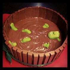 a cake with chocolate frosting and green decorations