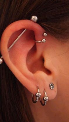 an ear with three different piercings on it