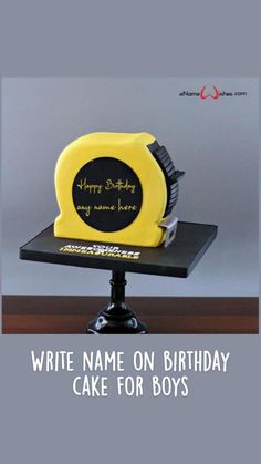 a yellow and black birthday cake sitting on top of a table