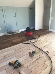 a room with hard wood floors and tools on the floor