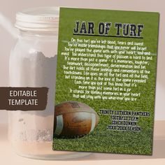 a jar filled with sand next to a football on top of a field