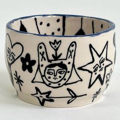 a ceramic bowl with black and white designs on it