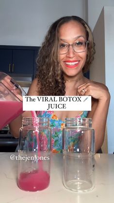 a woman holding a sign in front of two jars filled with pink liquid and the words, the virtual botox juice