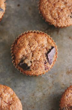 several muffins on a baking sheet with one cut in half