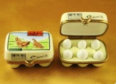 two tins filled with eggs sitting on top of a table