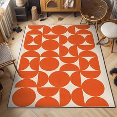 an orange and white area rug with circles on it in the middle of a room