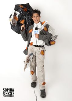 a young boy holding an umbrella and singing into a microphone