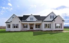 a large white house sitting on top of a lush green field