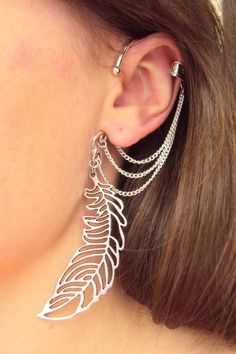 This unusual Feather ear cuff I made for a person who likes cosplay and Elven jewelry. It's a great idea for a Fairytale or Magic style party. No piercing needed to wear this ear cuff. It slips behind your ear and rest against your head with the dangles showing below the massive charm. The upper part of cuff is fake, no need a cartilage piercing. It's very comfortable and easy to wear. Fits both for left and right ears. The length of wing charm is about 2 inches. The price for one ear cuff. More Falling Feathers, Feather Ear Cuff, Earring Cuff, Feather Cuff, Ear Crawler, Elven Jewelry, Wrap Earrings, Mixed Metal Jewelry, Silver Ear Cuff