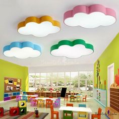 the children's playroom is brightly decorated with clouds and rainbows on the ceiling