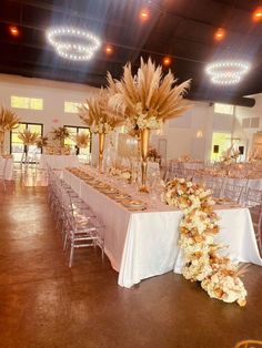 the tables are set with gold and white flowers