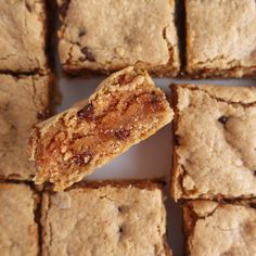 a close up of some food on a white surface with squares in the middle and one piece missing