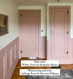 two pink doors in a white room with wood flooring and wooden paneling on the walls